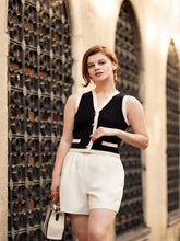 You can wear a black vest and a grey skirt.
